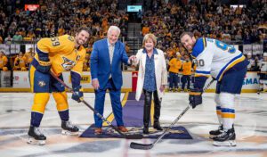 Terry Crisp and his wife Sheila, center, drop the puck during a Nashville Predators game against the St. Louis Blues. Photo by John Russell/Nashville Predators
